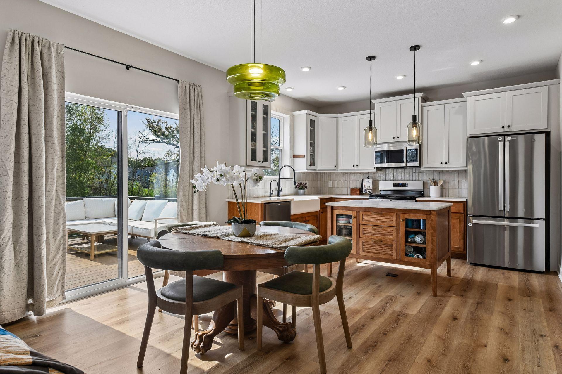 Just off the kitchen is sliding glass door to composite decking overlooking private backyard