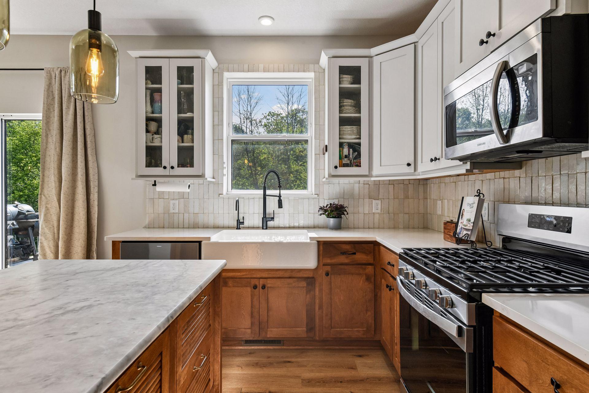 Stainless steel appliances, custom backsplash and warm cabinetry makes this kitchen a 10/10