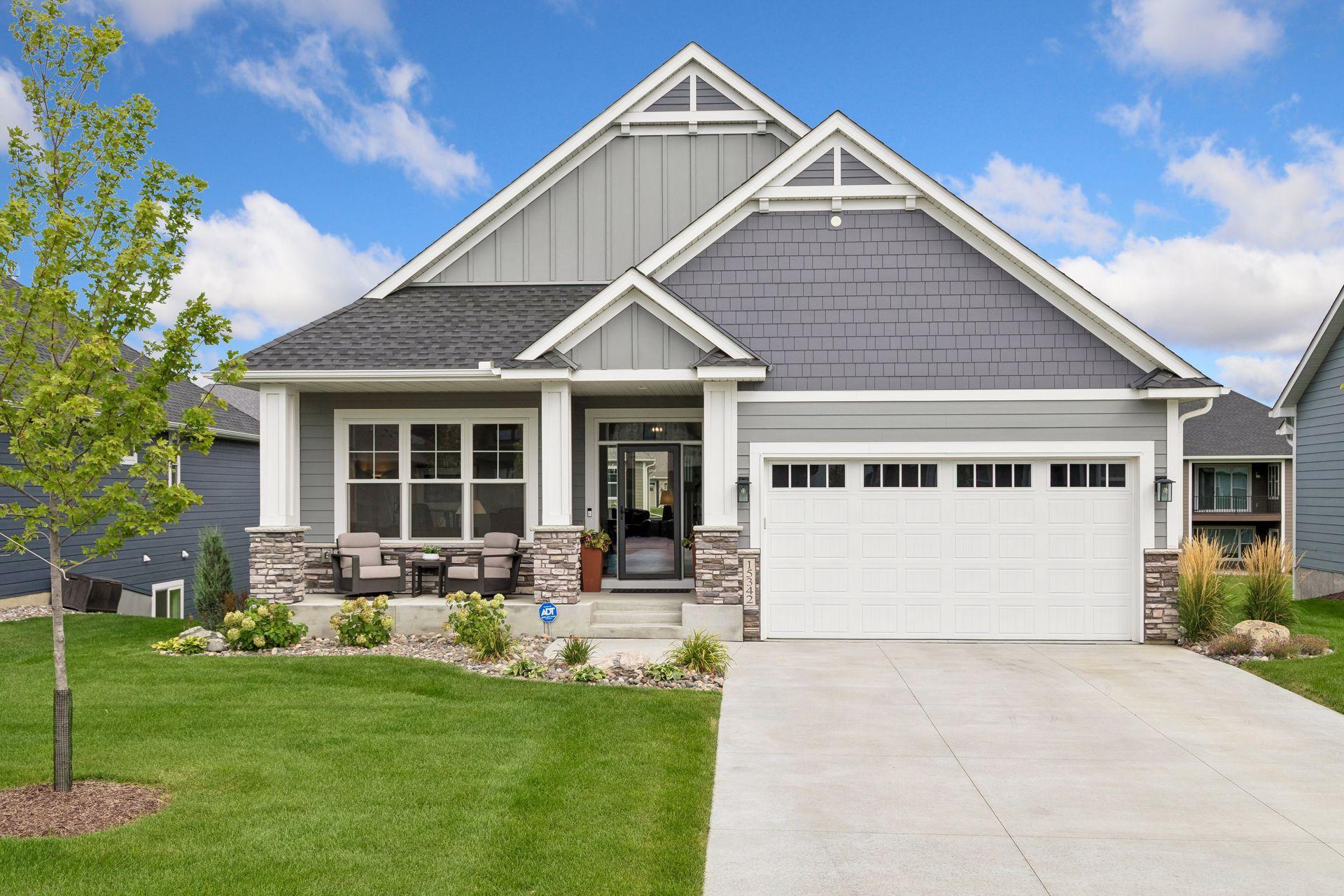 James Hardie on all 4 Sides with Stone Accents and a Concrete Driveway