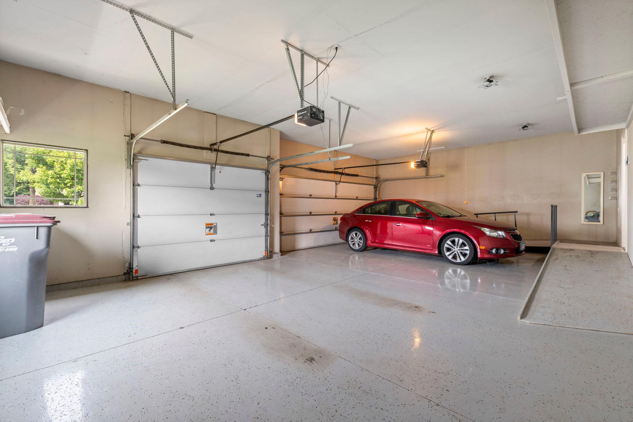 Oversized heated and insulated 3-car garage with wheelchair-accessible ramps.