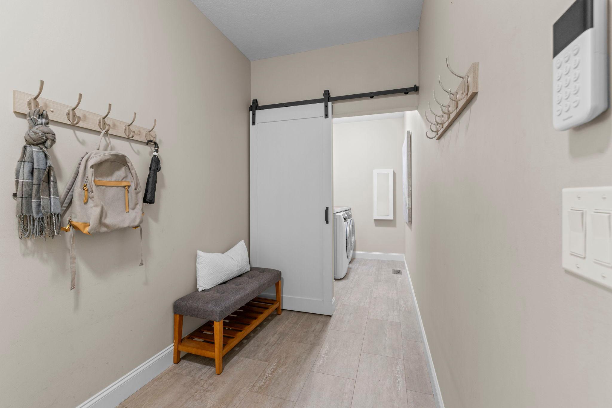 Mudroom with convenient access to the attached 3-car garage, laundry room, and kitchen.