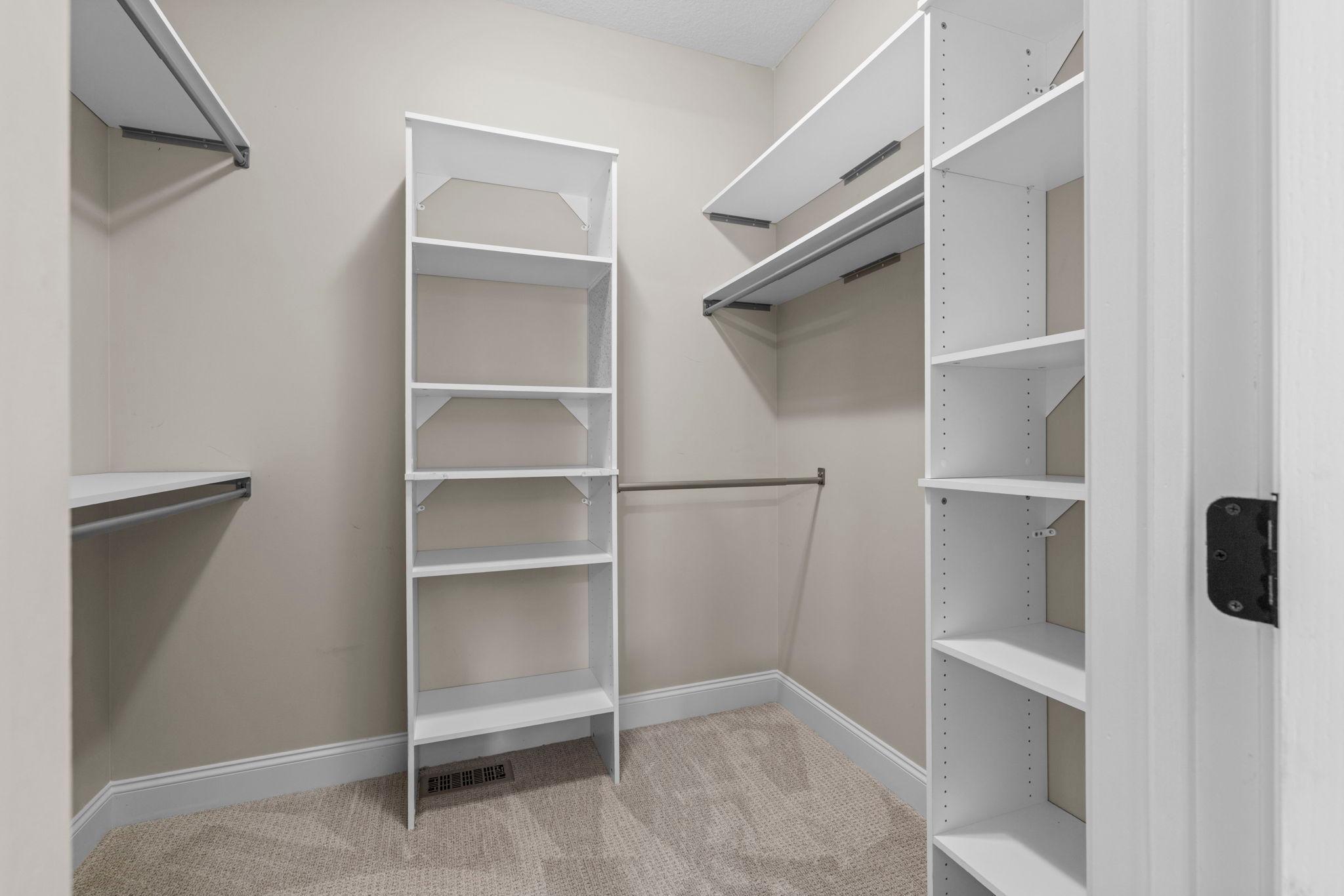 Spacious walk-in closet with built-in organization in the primary suite.
