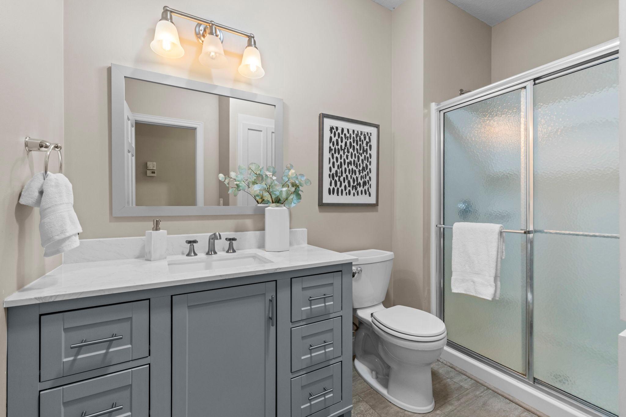 Recently updated 3/4 bathroom serving the main level.