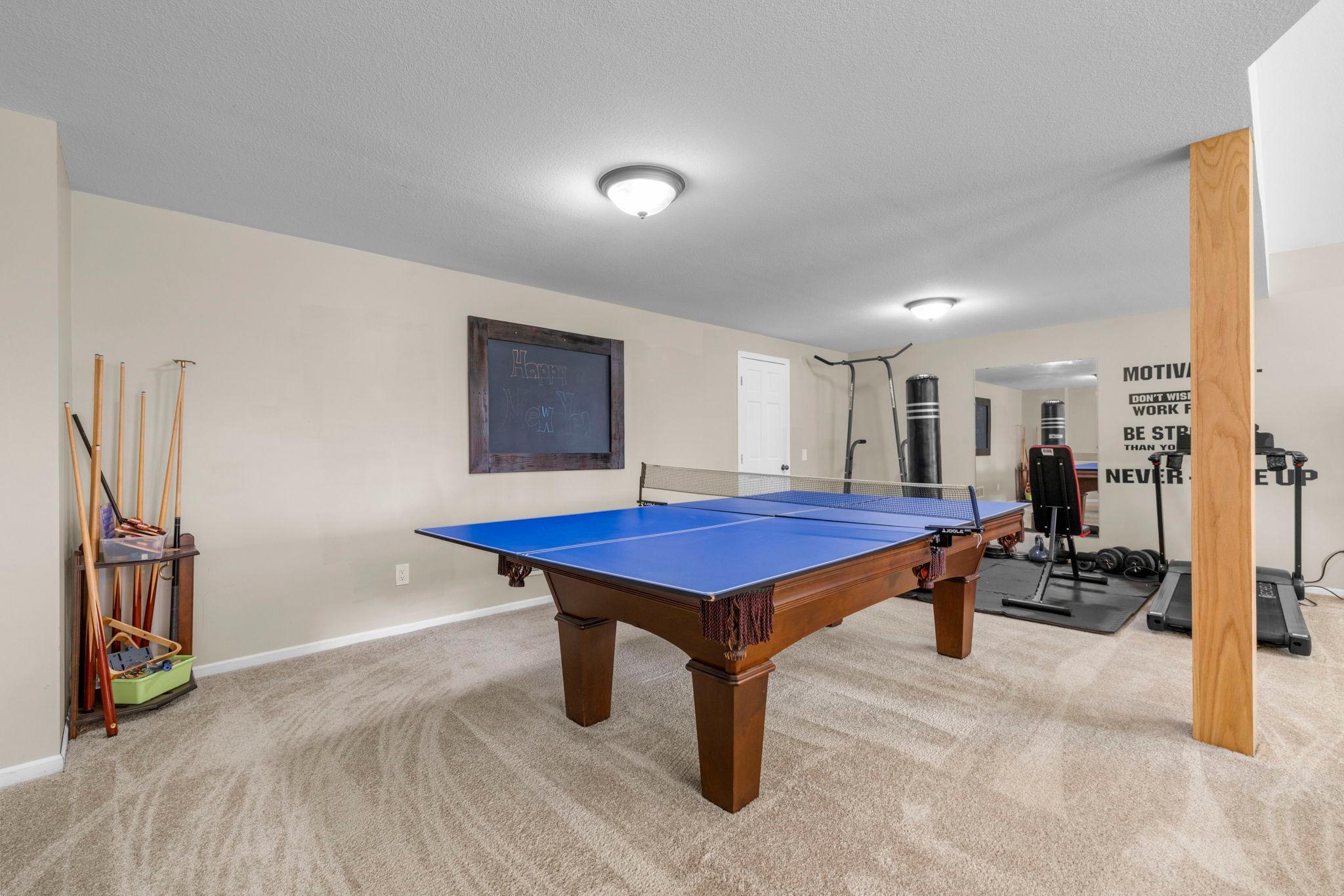 Versatile family room flex space perfect for workouts, games, or hobbies.