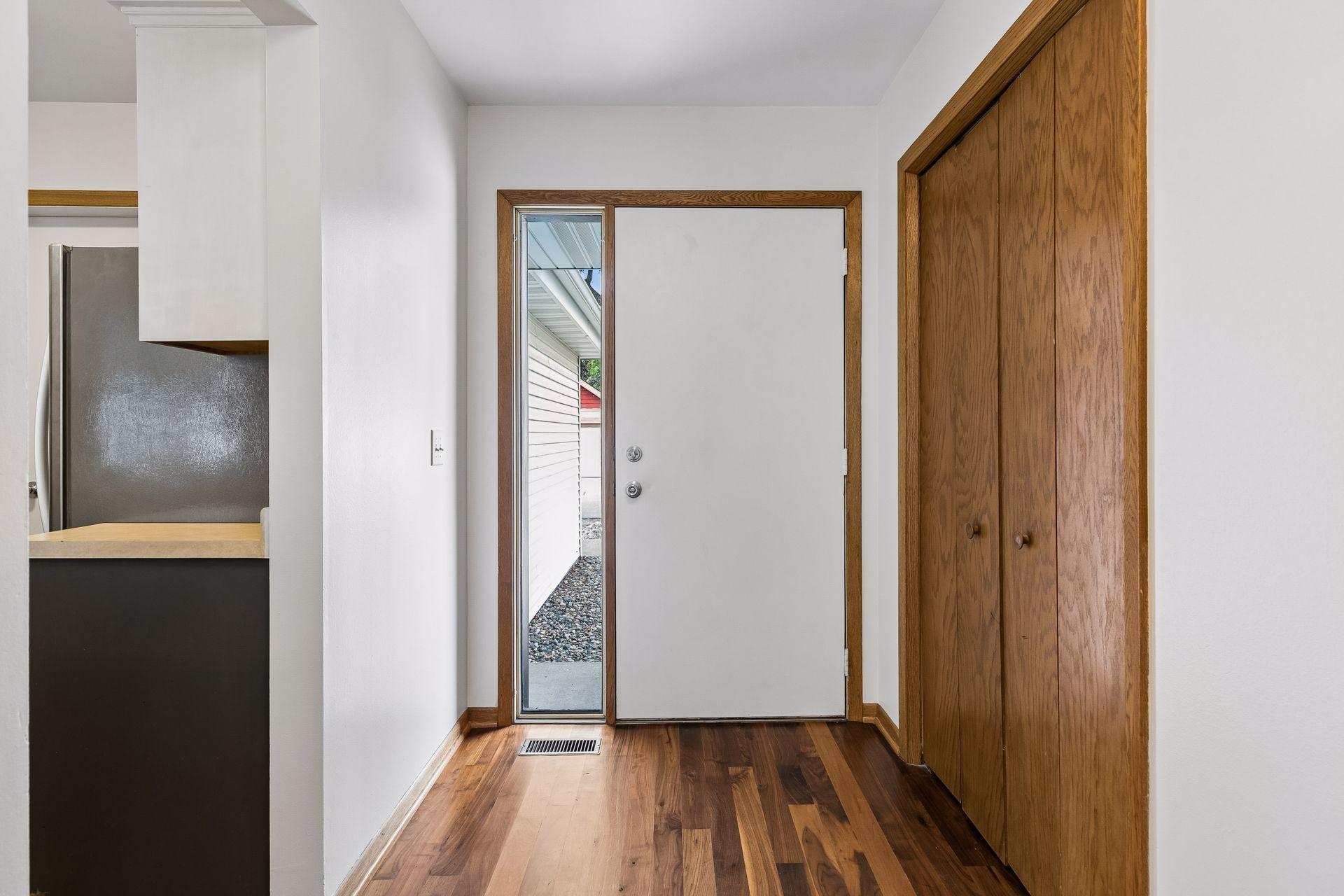 Light and bright foyer with conveniently located coat closet and beautiful hardwood floors.