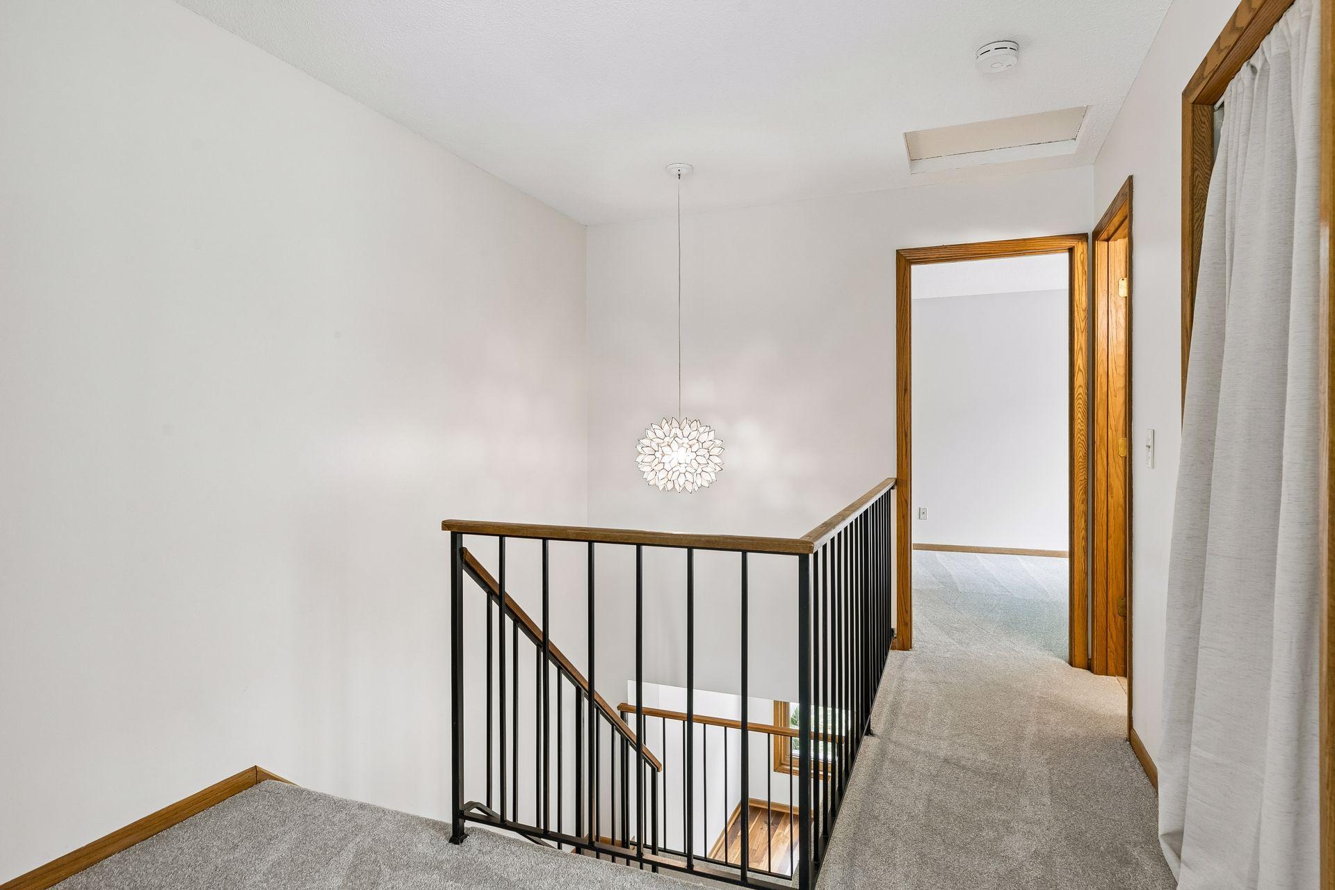 Fresh new carpet and a stylish statement light fixture brighten the upper level and give the space a fresh, updated feel.