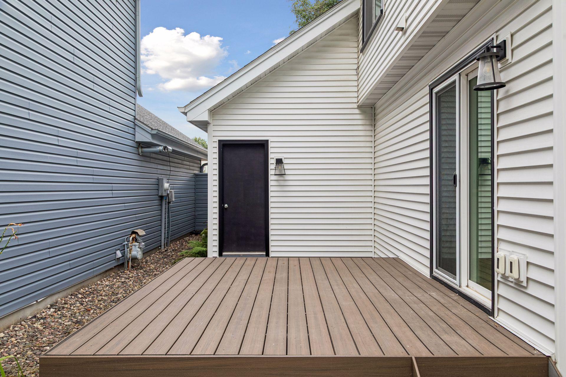 Enjoy outdoor living on the maintenance-free deck and adjoining patio, offering a private space to relax, entertain, or enjoy the warmer months.
