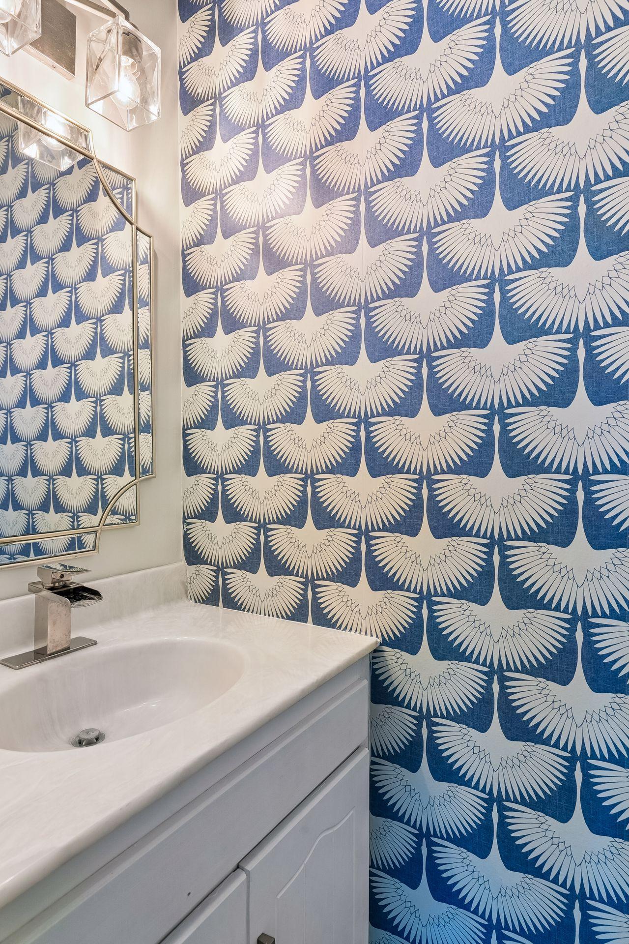 Convenient main-level half bath with an updated vanity, modern fixtures, and a fun pop of personality