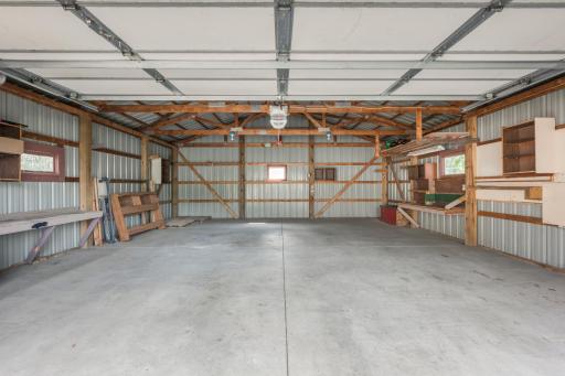 This garage is more than a place to park! Generous open space, concrete floor, shelving, and work areas leave room for vehicles, tools, toys, and projects.