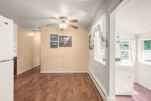 Comfortable dining space with wood flooring and an easy flow between the kitchen and adjoining living areas.