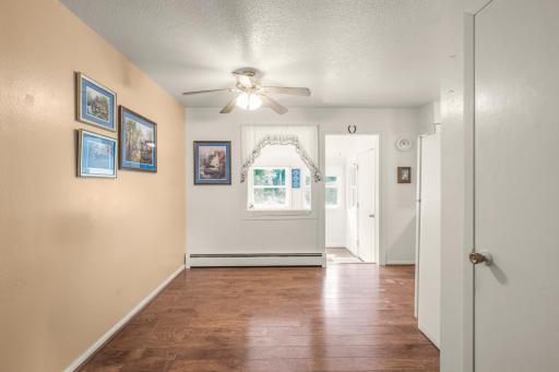 A bright, functional layout connects the dining area to the kitchen and nearby three-season/laundry space.