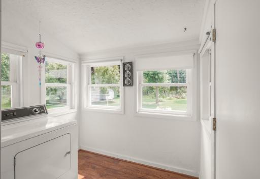 Convenient main-level laundry room with abundant windows and natural light, keeping everyday chores right where you need them with true one-level living.