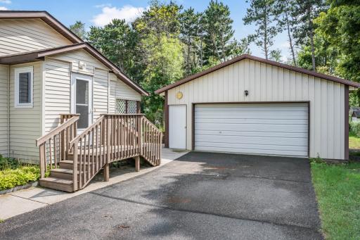 Spacious detached garage with a concrete floor and plenty of room for vehicles, tools, toys, and hobbies.