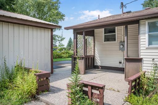 Exposed-aggregate patio tucked between the home and garage, creating a convenient outdoor space to relax or entertain.