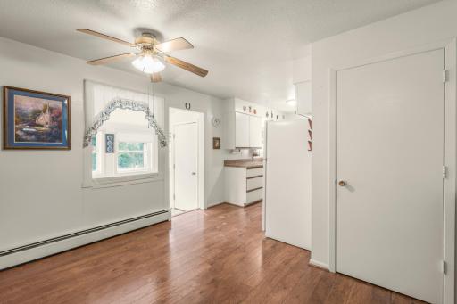 Wood flooring carries through the dining area and kitchen, helping create a comfortable flow through the heart of the home.