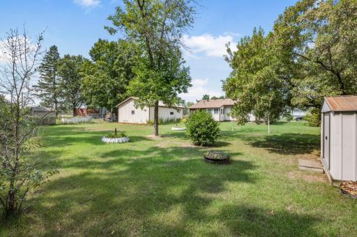 Mature trees provide shade while the open lawn leaves plenty of room to make this backyard your own.