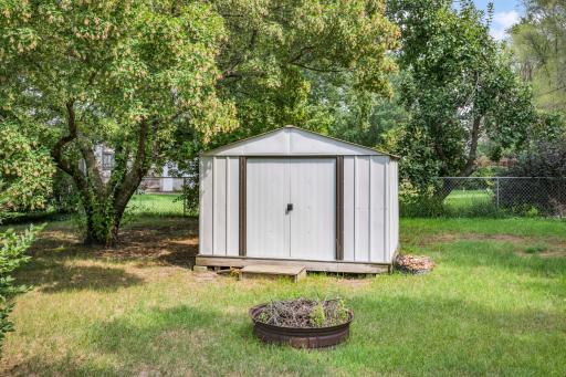 An additional backyard storage shed provides a handy spot for lawn equipment, gardening supplies, and outdoor gear.