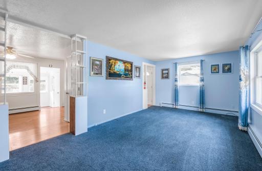 The living room connects easily to the dining and kitchen areas, creating a comfortable flow for everyday living.