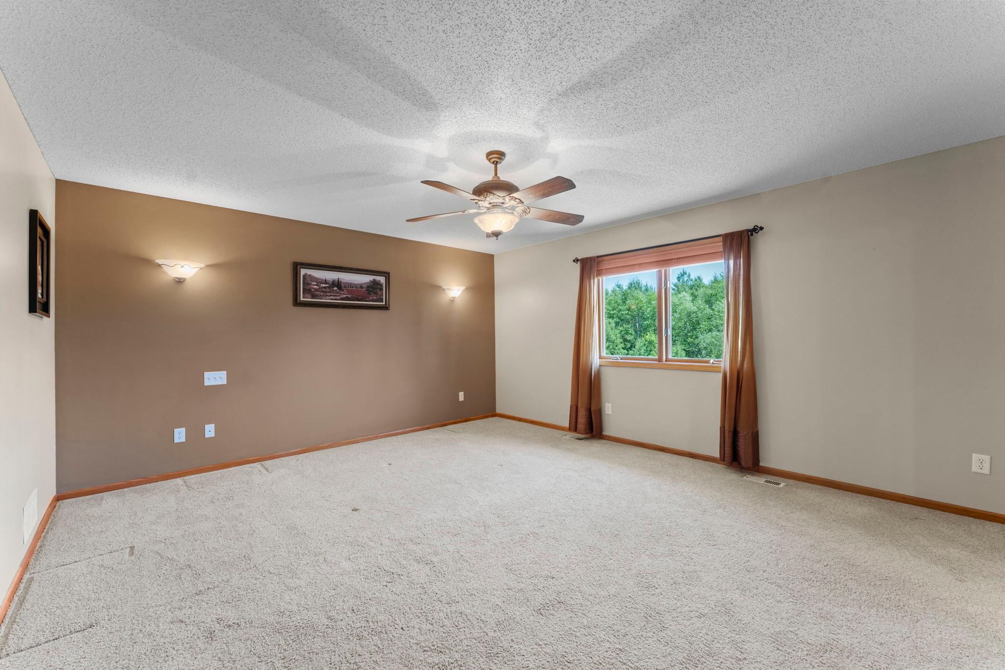 Large Primary Bedroom with attached deluxe bath and large walk-in closet