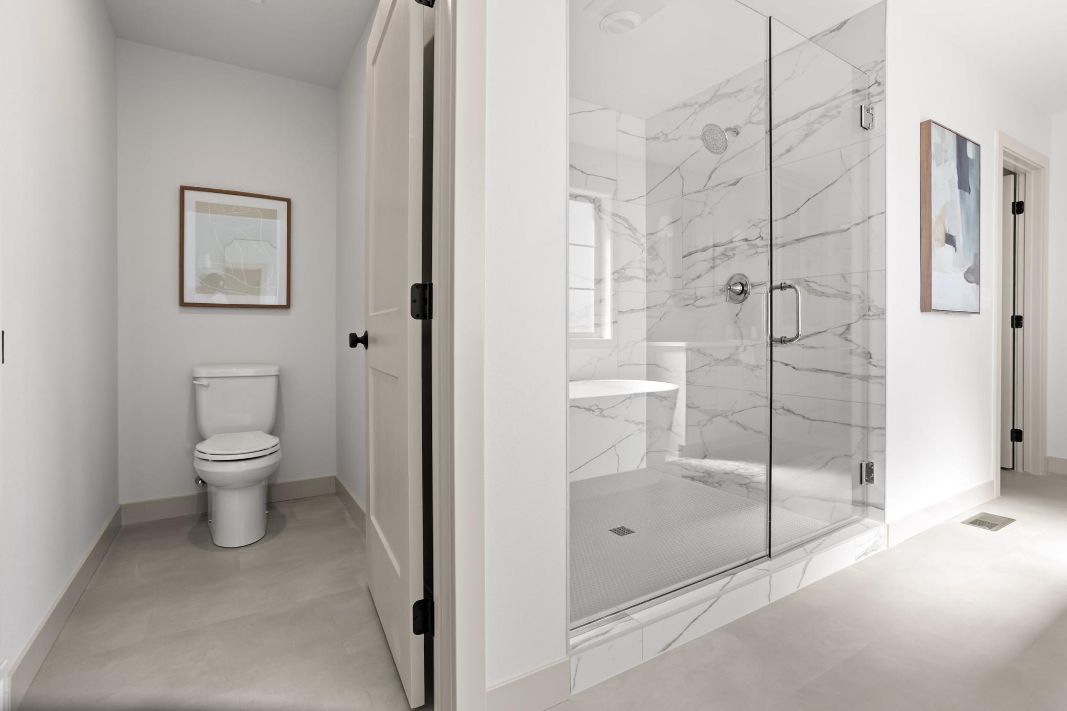 Private stool space, glass enclosed tile shower