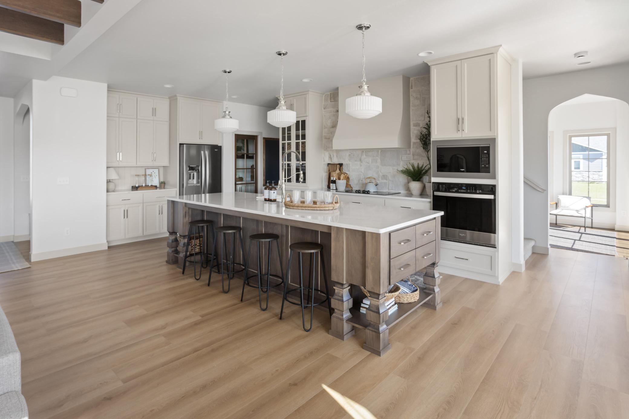 Custom hood + cabinets to 9', stone + quartz backsplash, 10' island with furniture legs/ drawers