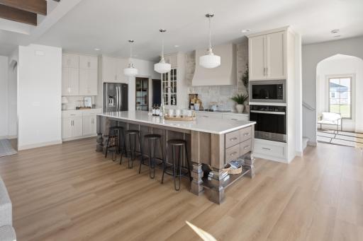 Custom hood + cabinets to 9', stone + quartz backsplash, 10' island with furniture legs/ drawers