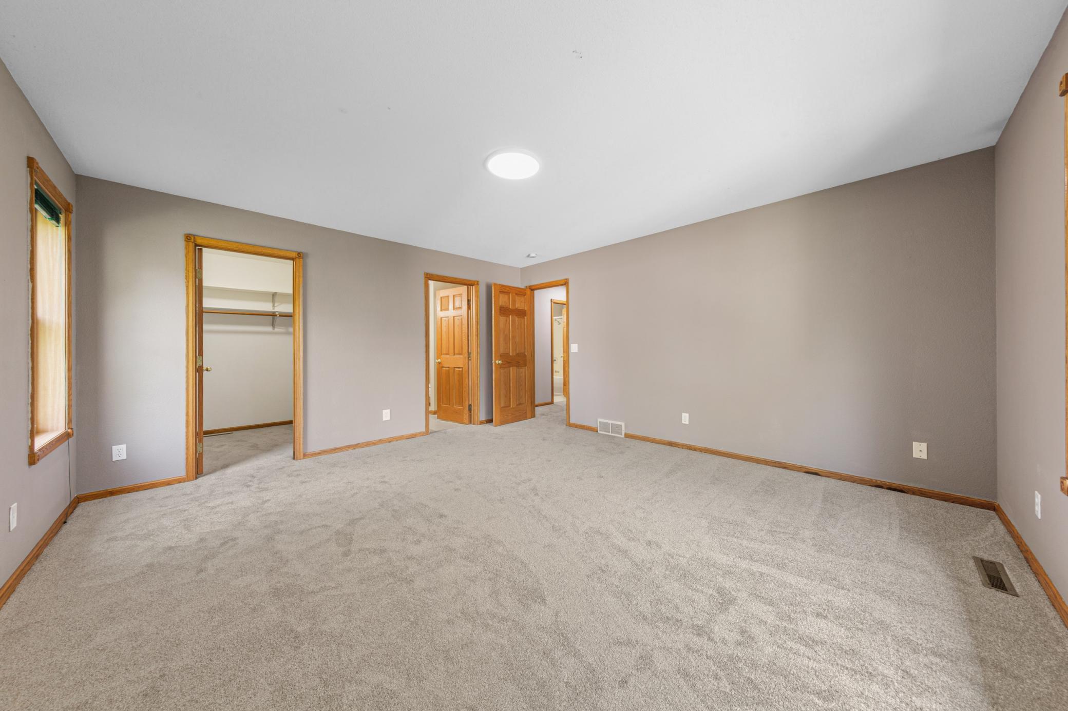 Primary bedroom with private bath and walk-in closet