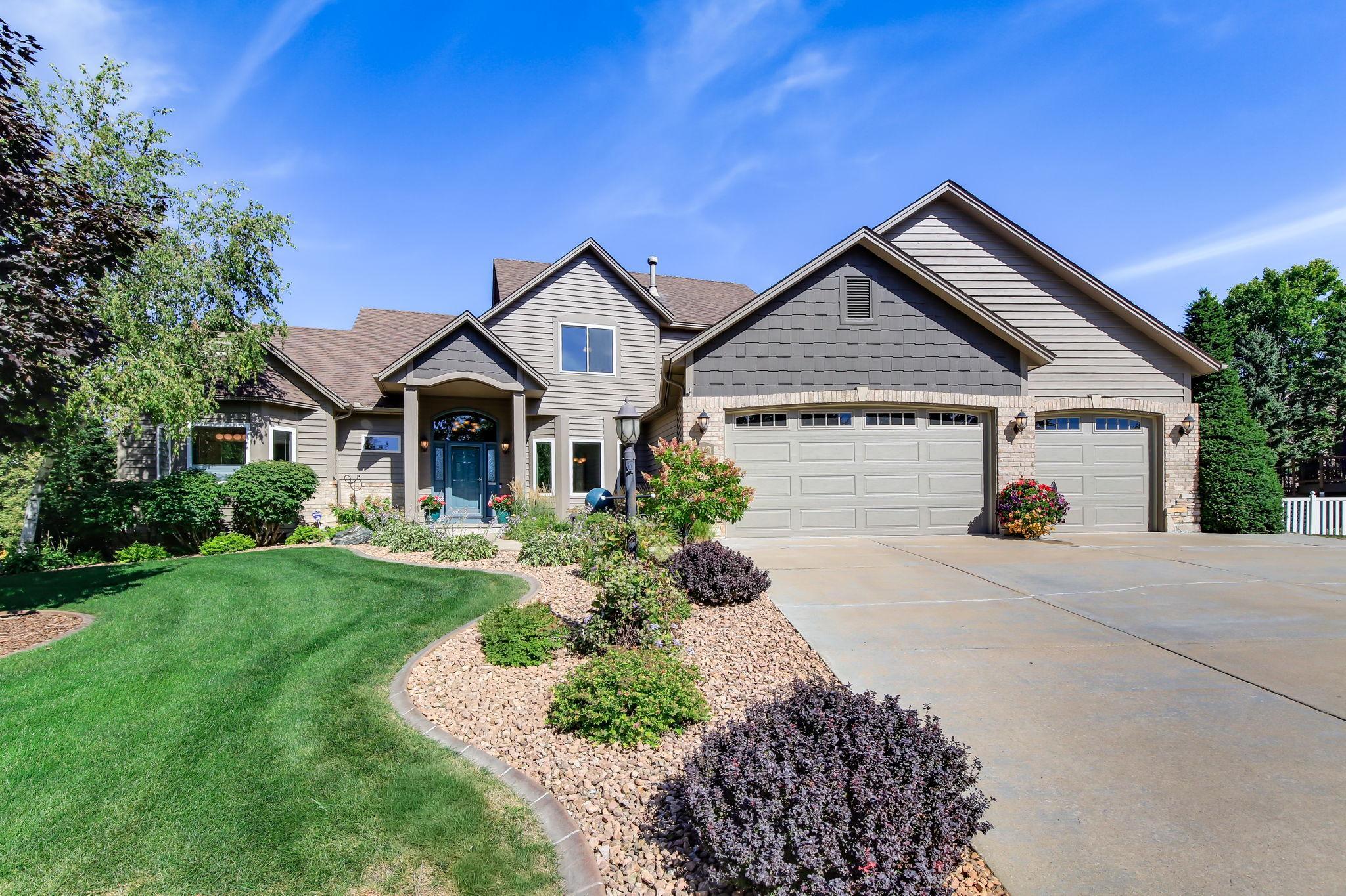 GORGEOUS!! Curb appeal that delivers a polished, welcoming first impression — lush greens, clean lines, and a beautifully maintained exterior.