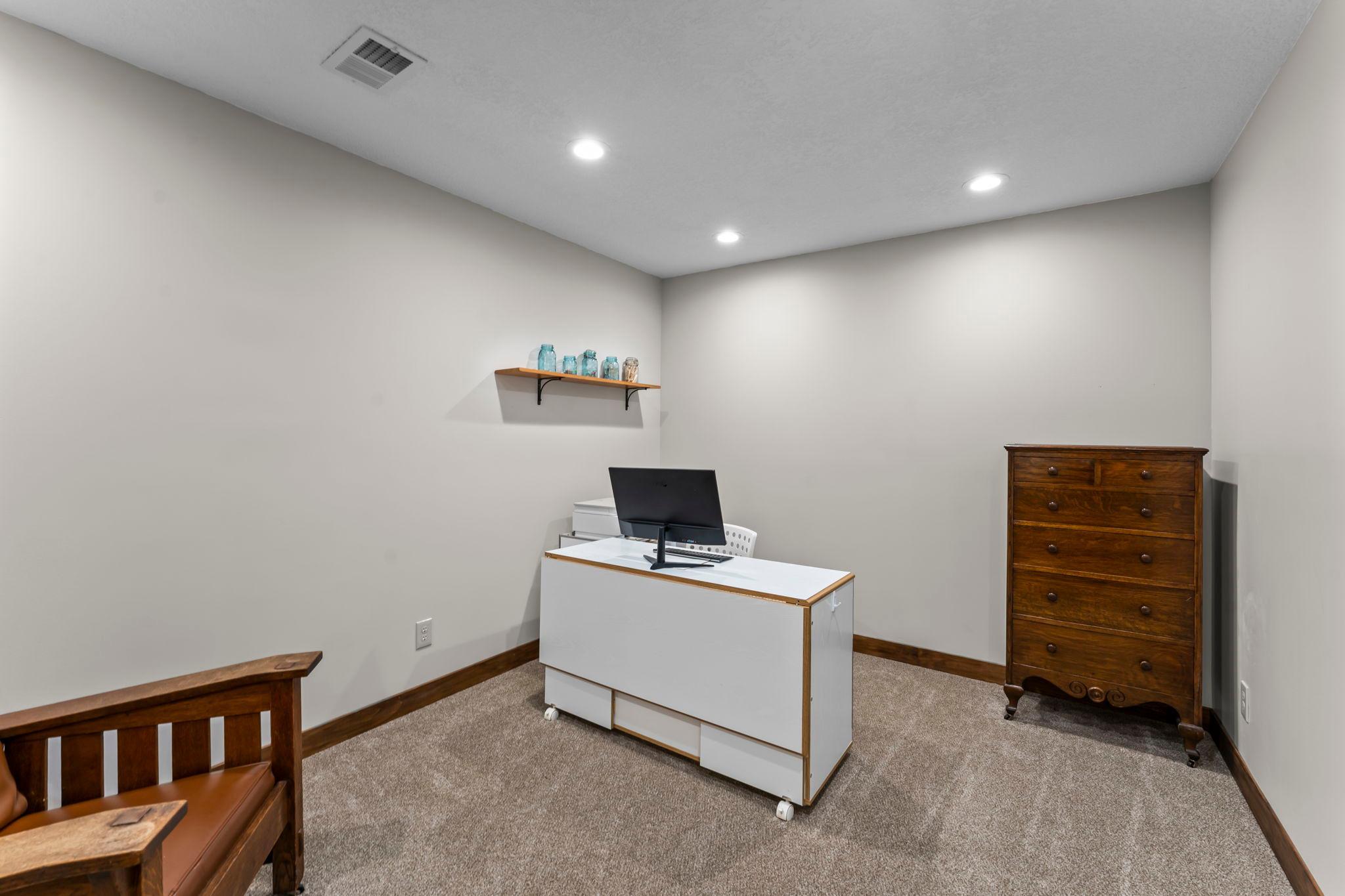 A dedicated office or flex space, created in 2024, resides on the lower level with sliding barn doors that add character and versatility.