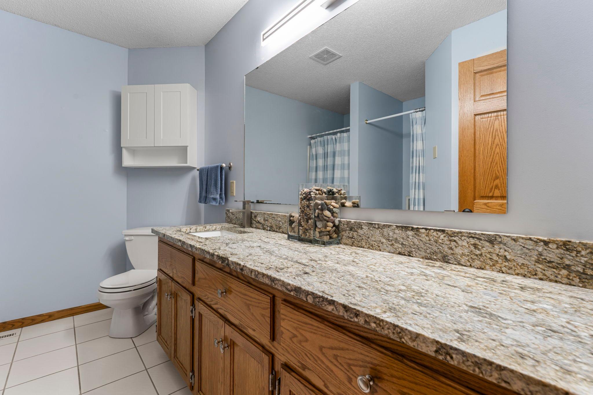 Shared ¾ bath with extended counter space and washer/dryer hookups, allowing for convenient main-level living if desired.