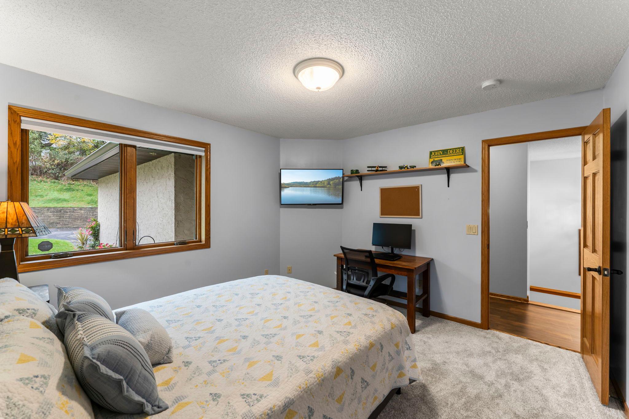 The main-level primary suite is well sized with plush carpeting and a 7x4 walk-in closet with built-ins.