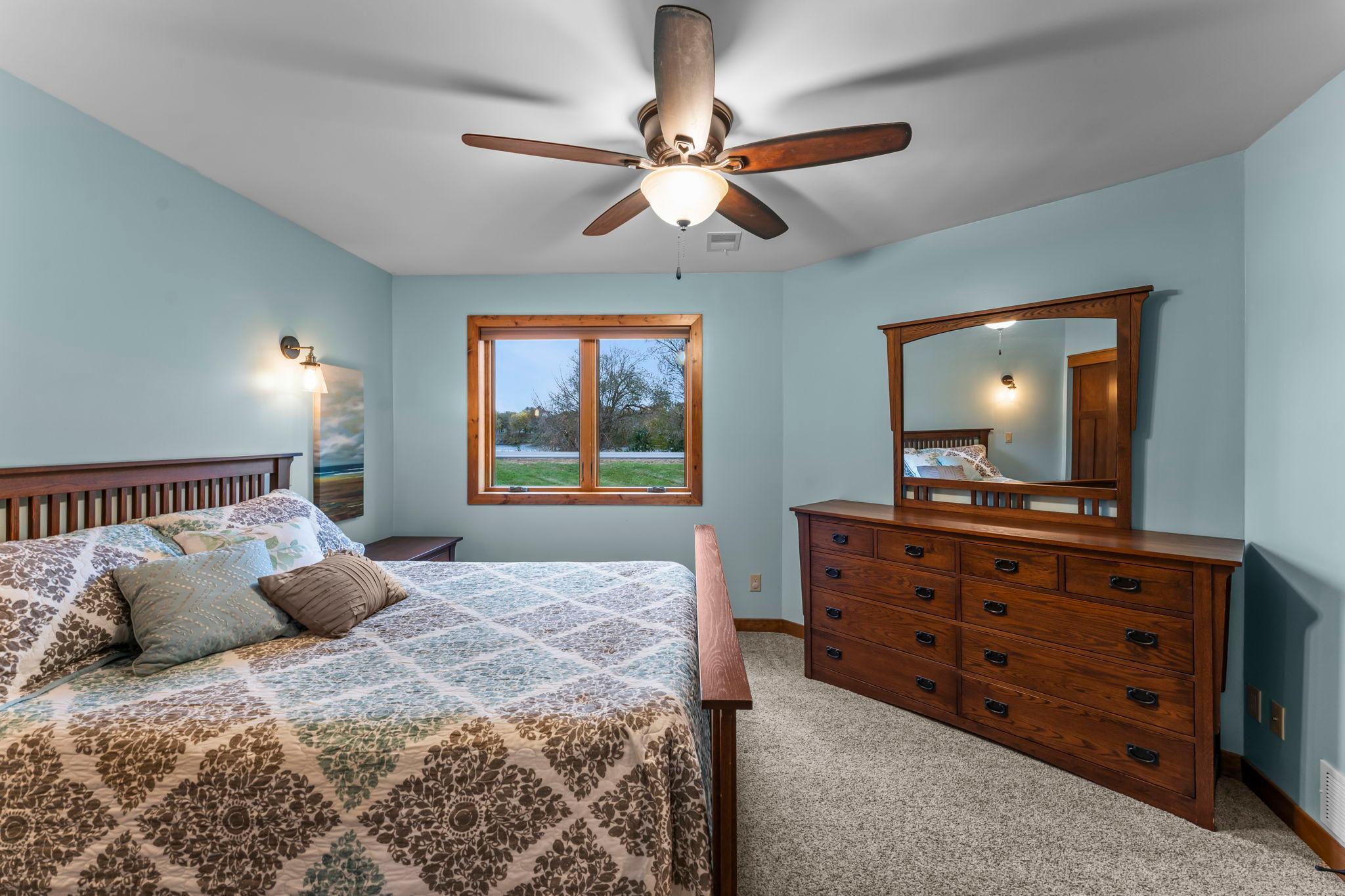 The second bedroom is also located on this level, offering an ideal private guest room or secondary suite accessed through French doors.
