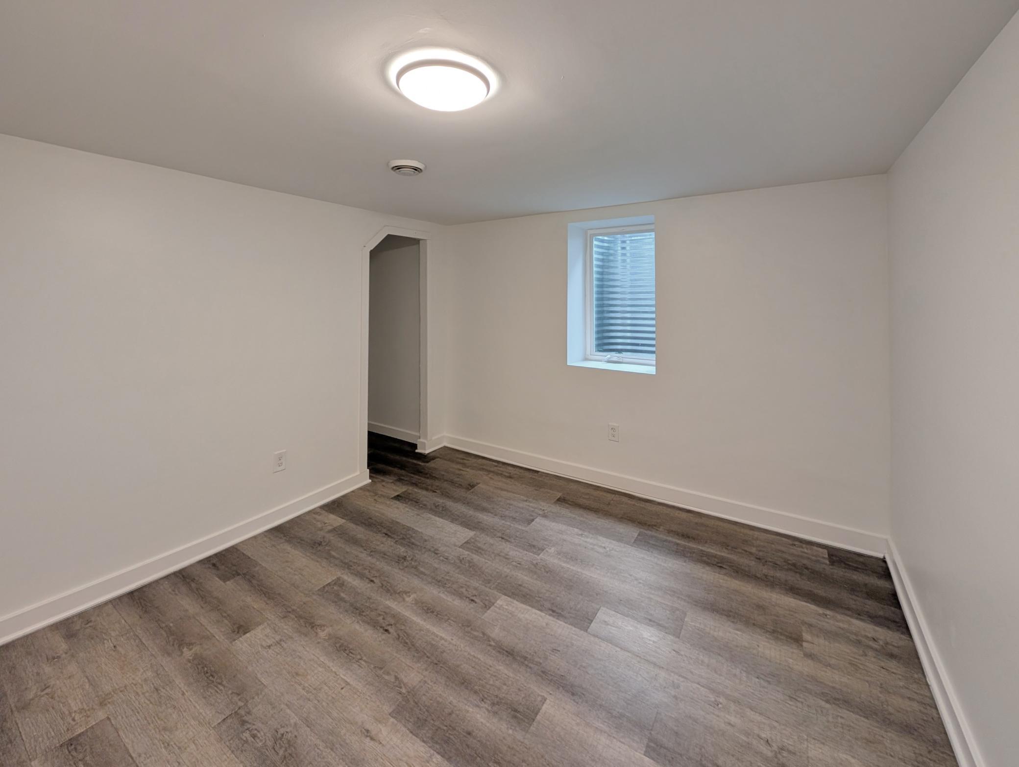 Second bedroom with natural light and light fixture!