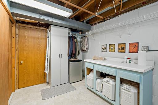 Additional cabinetry, open shelving, and hanging space provide plenty of practical storage & organization, making this laundry area functional & spacious. Be sure to check out the cedar-lined closet, offering a great additional storage option.