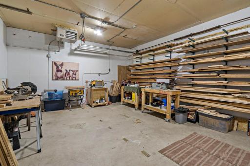 The separate heated workshop garage offers an impressive amount of space for woodworking, hobbies or projects, with room for workbenches, tools and organized material storage.