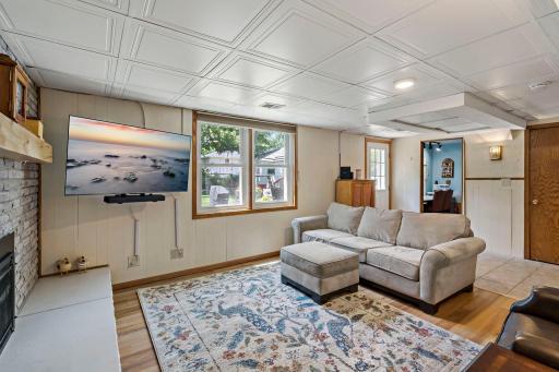 This angle showcases the spacious lower-level family room and its easy access to the backyard, creating a versatile space for relaxing, entertaining and enjoying indoor-outdoor living.