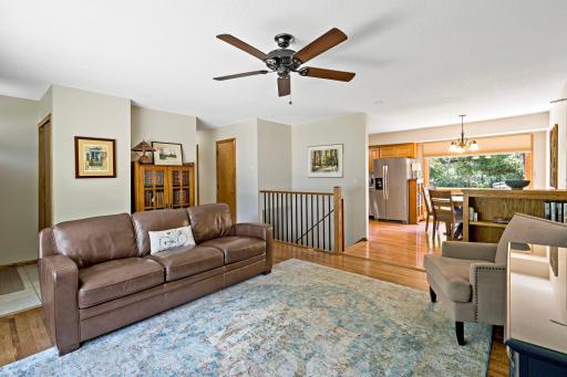 This view showcases the home’s comfortable main-level layout, with the living room flowing toward the dining and kitchen areas for an easy connection between everyday living spaces.