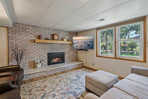 This view highlights the family room’s decorative ceiling detail and expansive backyard-facing windows, adding character and natural light to this inviting lower-level living space.