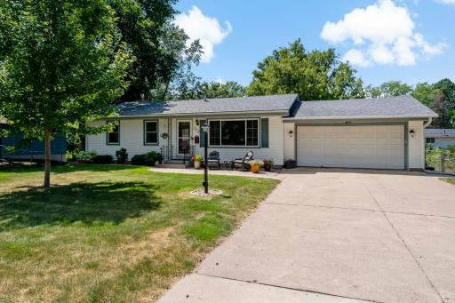 Welcome to this charming Bloomington rambler with wonderful curb appeal, mature trees, established landscaping and a spacious two-car attached garage. A wide driveway provides plenty of room for parking and easy everyday access.