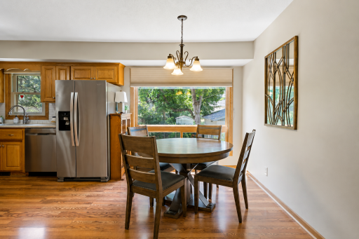 The dining area offers a warm and inviting setting with a large window overlooking the backyard and easy access to the kitchen—creating a comfortable space for everyday meals and entertaining.