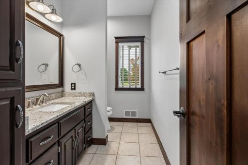 Half-bath with upgraded vanity and tile to service main floor