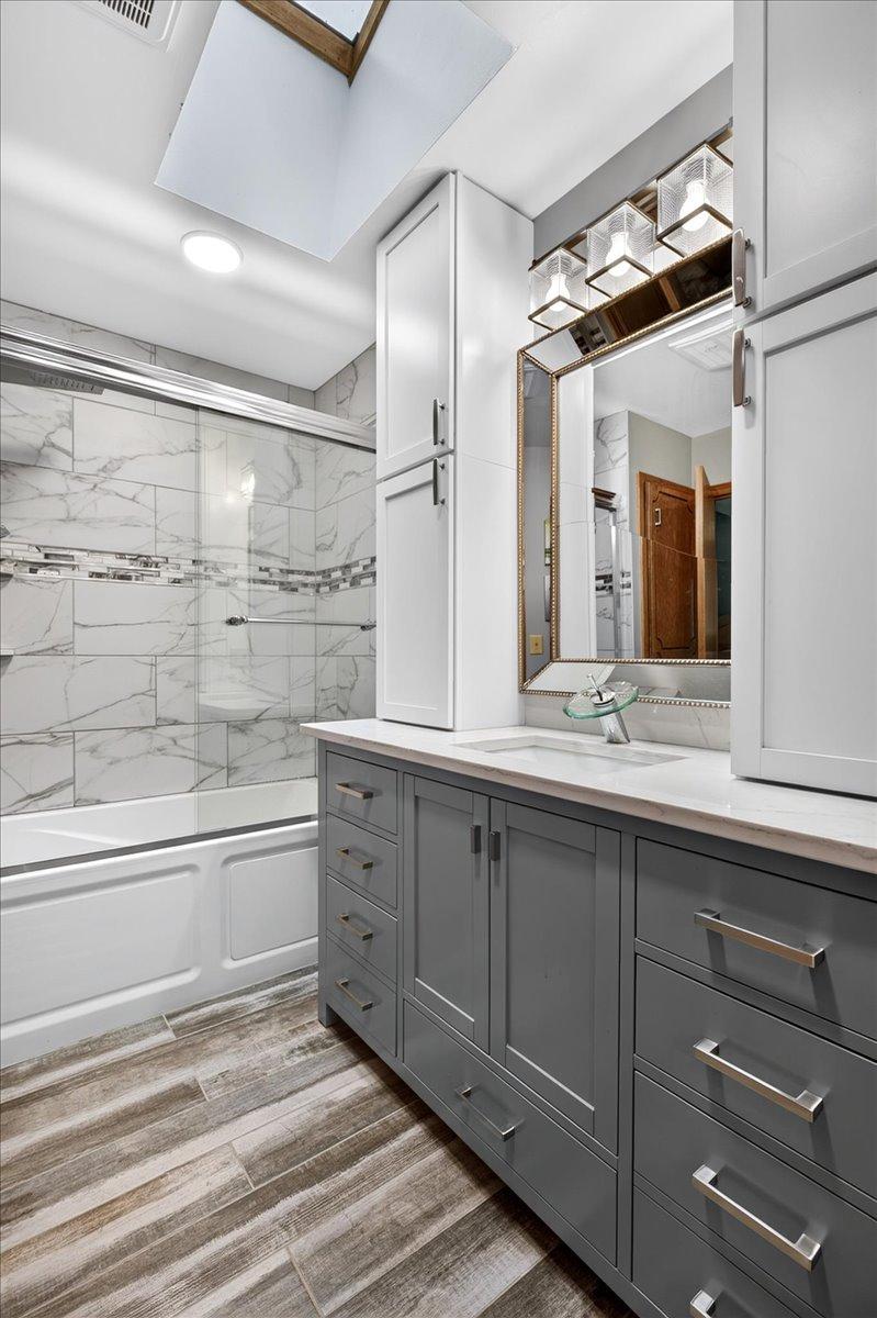 Main full Bath with tile floor, custom raised Vanity, recessed lighting