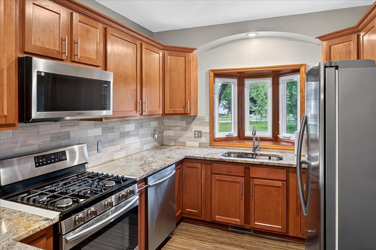 Stunning custom tile backsplash, bayed Kitchen window, undermount stainless sink