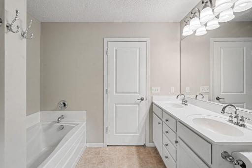 Primary Full Bathroom with dual sinks and jetted tub
