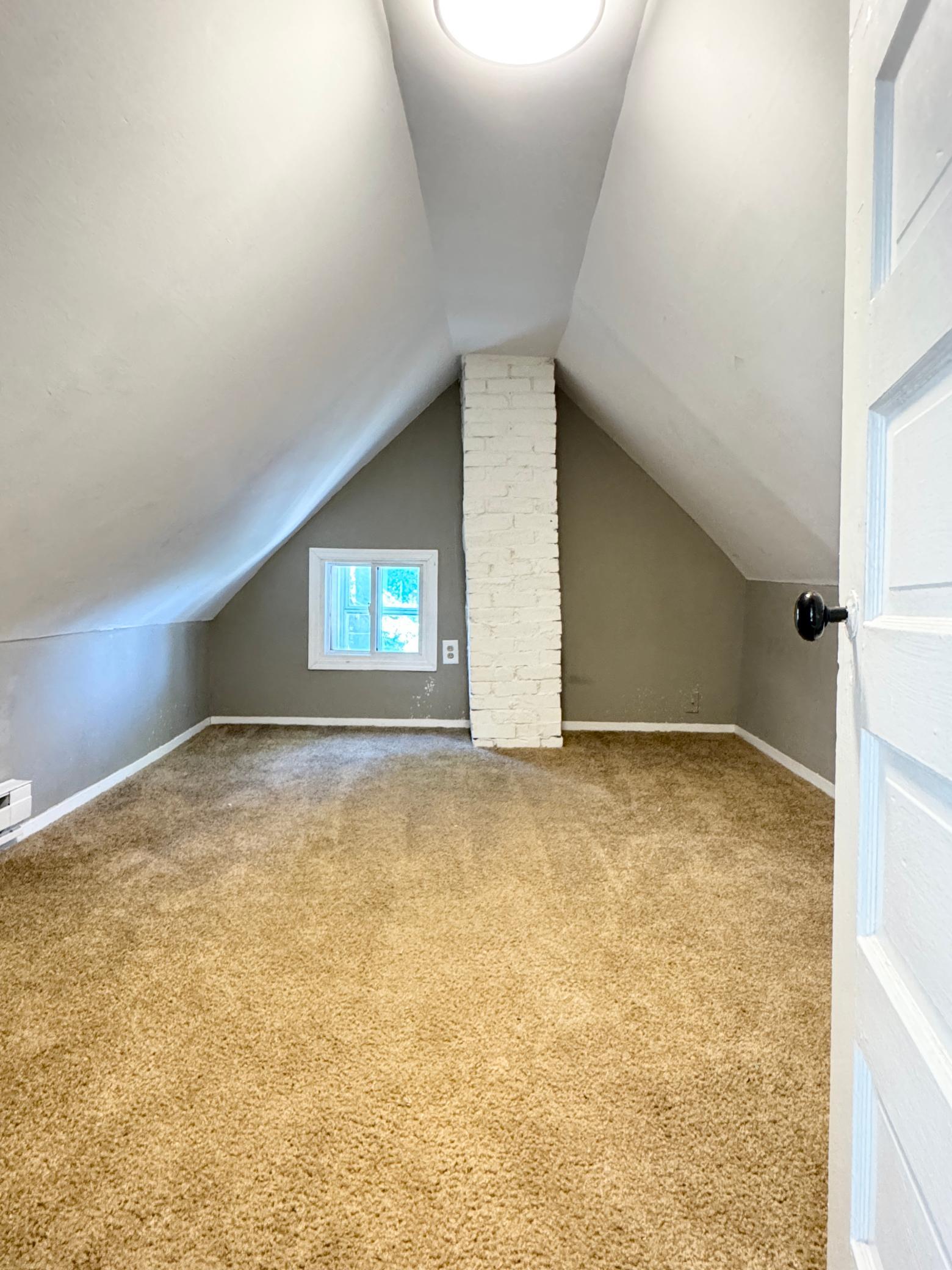 Upper-level room with charming sloped ceilings and plenty of room to make the space your own.