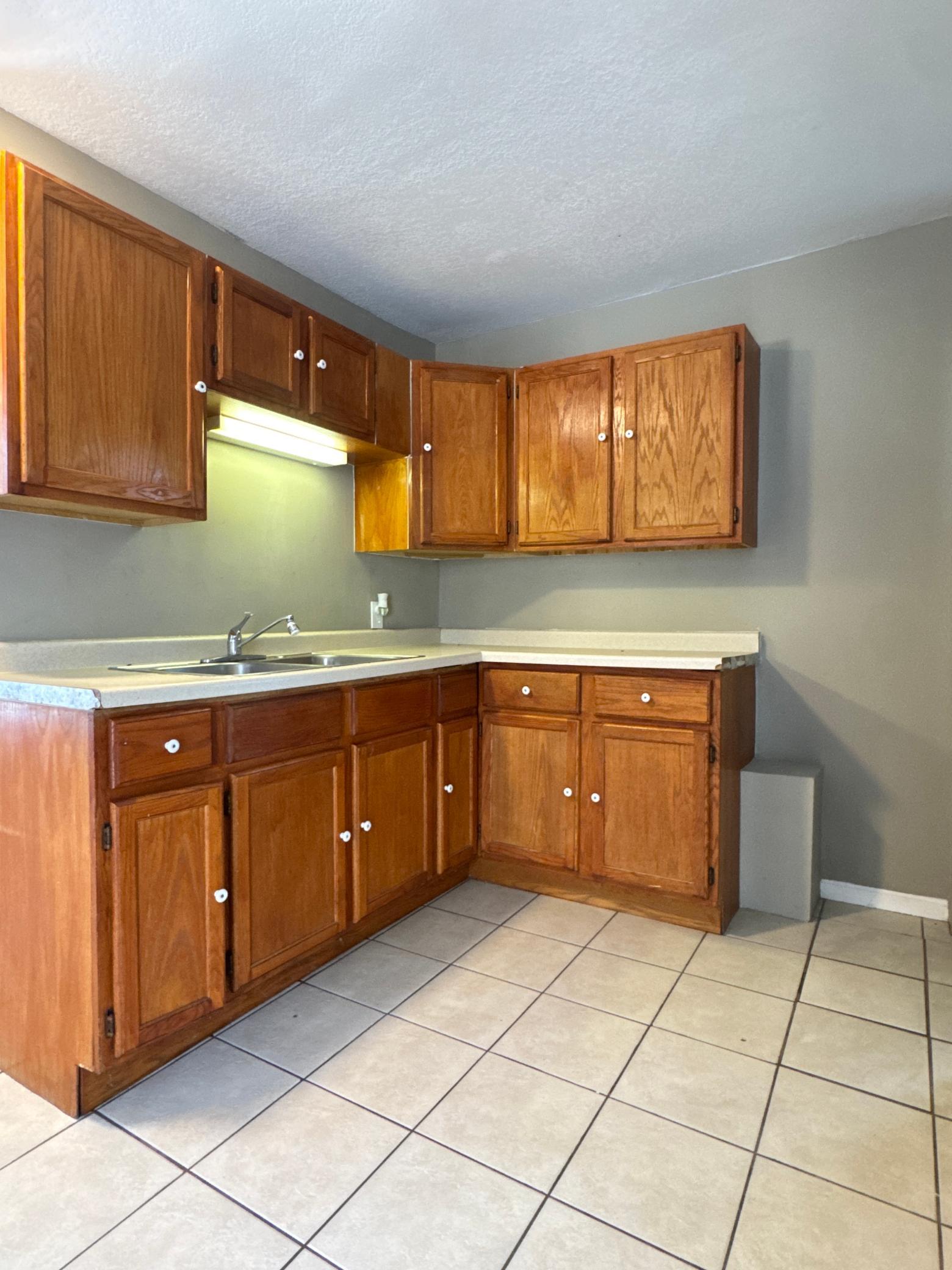 Warm wood cabinetry provides generous storage throughout the kitchen.