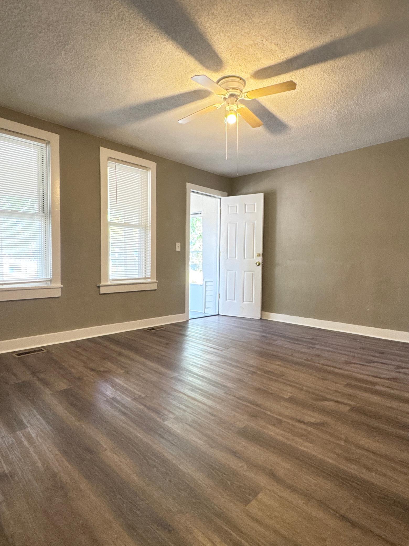 Comfortable main-level living room featuring newer paint, updated flooring and plenty of natural light.