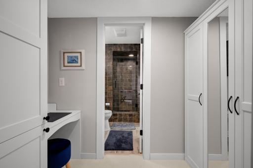 Redesigned closet featuring custom cabinetry and an armoire for added storage.