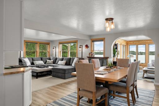 Informal dining, living room, and sunroom flow seamlessly together, creating an open and connected main-level living space.