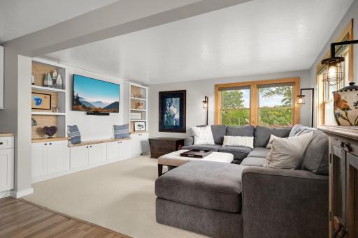 Living room featuring new built-in cabinetry, bookshelves, and shiplap detailing.